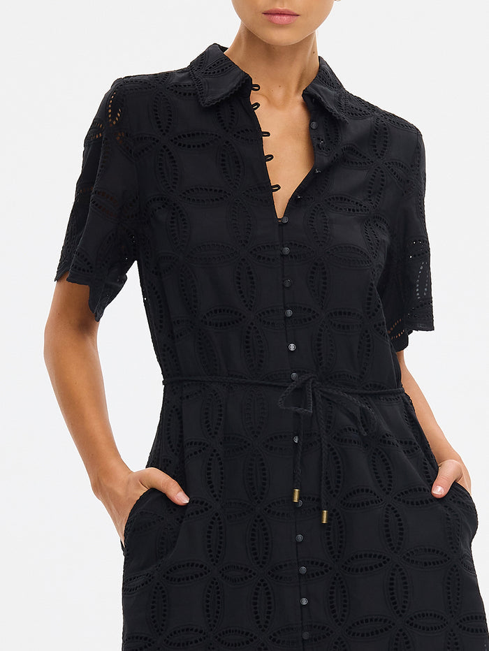 Black dress with intricate cut-out design on a white background