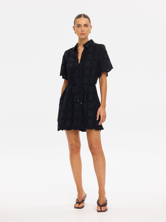 Woman wearing a black dress on a white background
