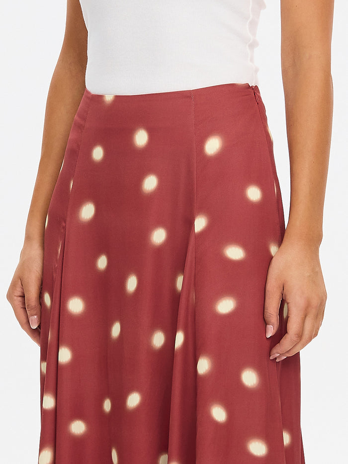 KIVARI Saro Maxi Skirt in Brick – close-up of polka dot fabric detail on flowing maxi skirt