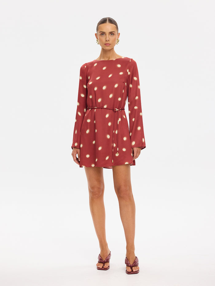 KIVARI Saro Mini Dress in Brick – long-sleeve polka dot mini dress with tie waist, front view