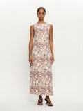 Woman wearing a sleeveless floral dress on a white background