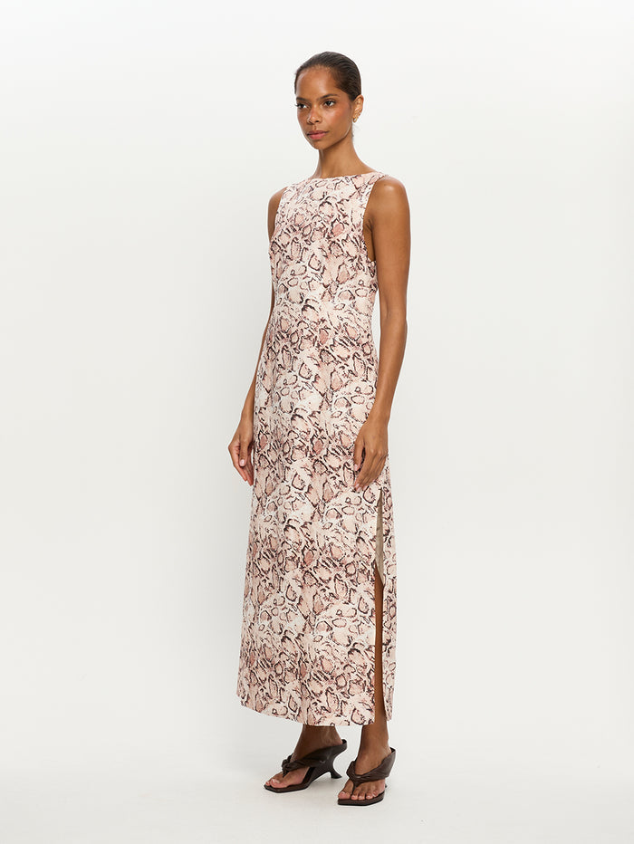 Woman wearing a snake print dress on a white background