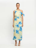 Woman wearing a one-shoulder dress with blue floral pattern on a white background