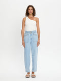 Woman wearing light blue jeans and a white top on a white background