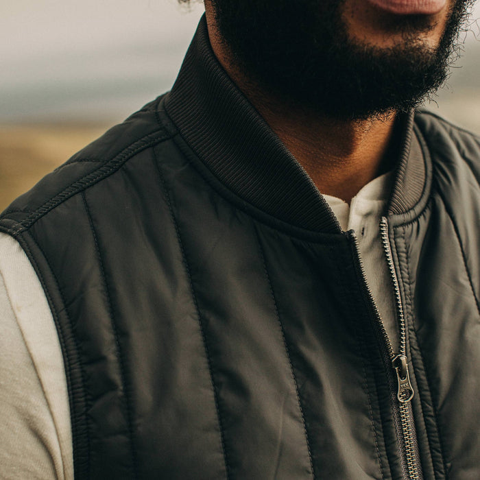 fit model wearing The Able Vest in Quilted Charcoal, chest detail