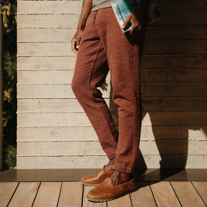 fit model walking with his hands in the pockets of The Apres Pant in Black Cherry Sashiko