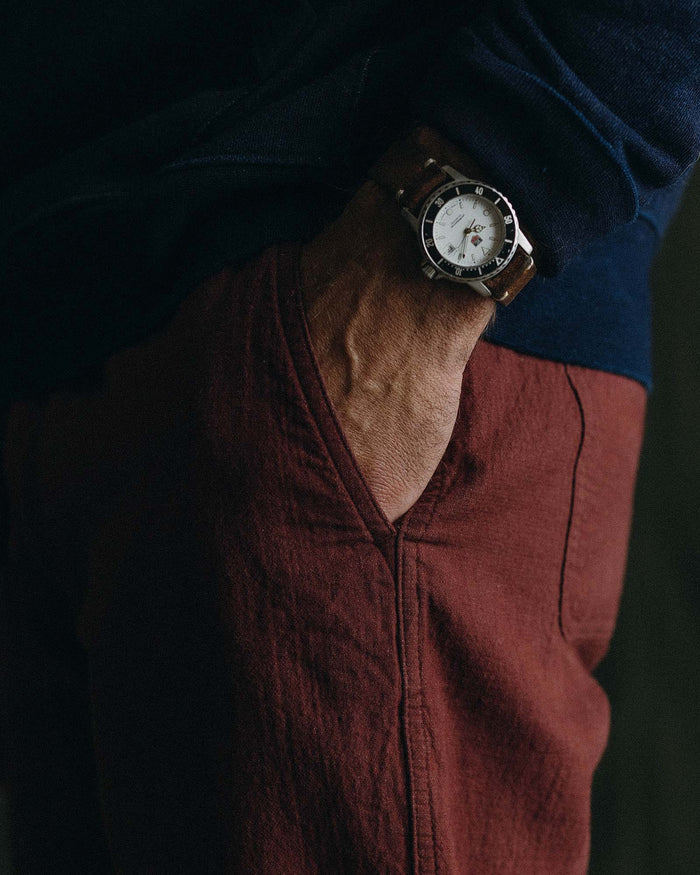 fit model showing off the pockets on The Apres Pant in Burgundy Double Cloth