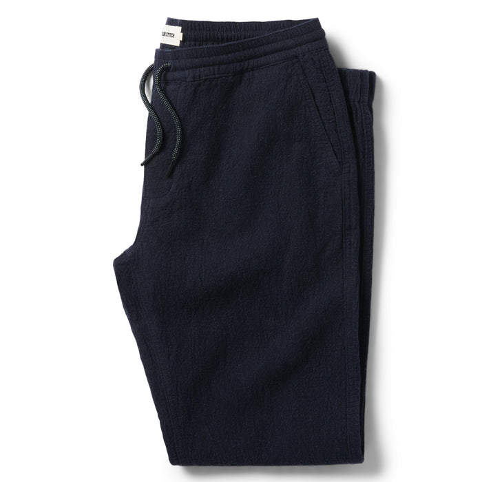 flatlay of The Apres Pant in Charcoal Double Cloth folded