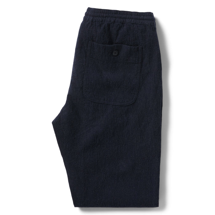 flatlay of the back of The Apres Pant in Charcoal Double Cloth folded