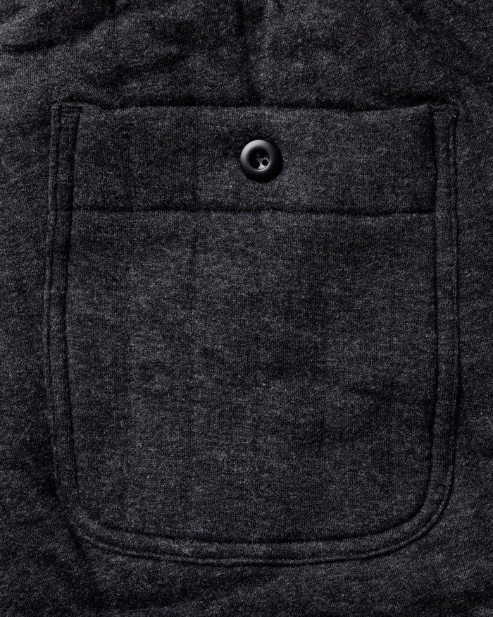 material shot of the back pocket on The Apres Pant in Heather Coal Quilted Jersey
