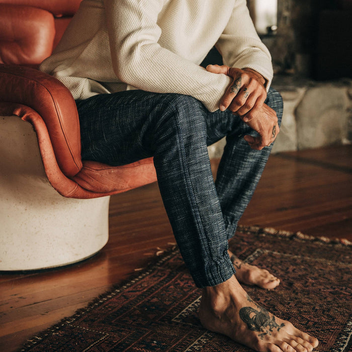 fit model wearing The Apres Pant in Indigo Slub, sitting