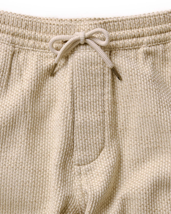 fit model showing the cuffs on The Apres Pant in Natural Sashiko