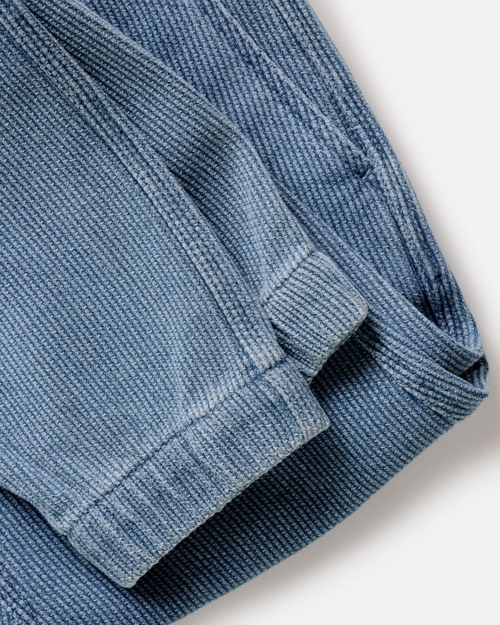folded flatlay of the back of The Apres Pant in Washed Indigo Sashiko