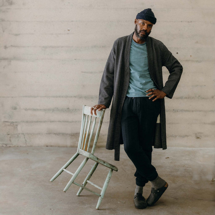 fit model leaning against a chair wearing The Apres Robe in Charcoal Sashiko
