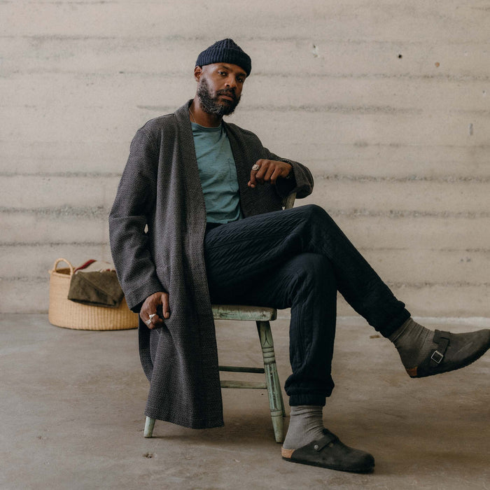 fit model sitting wearing The Apres Robe in Charcoal Sashiko