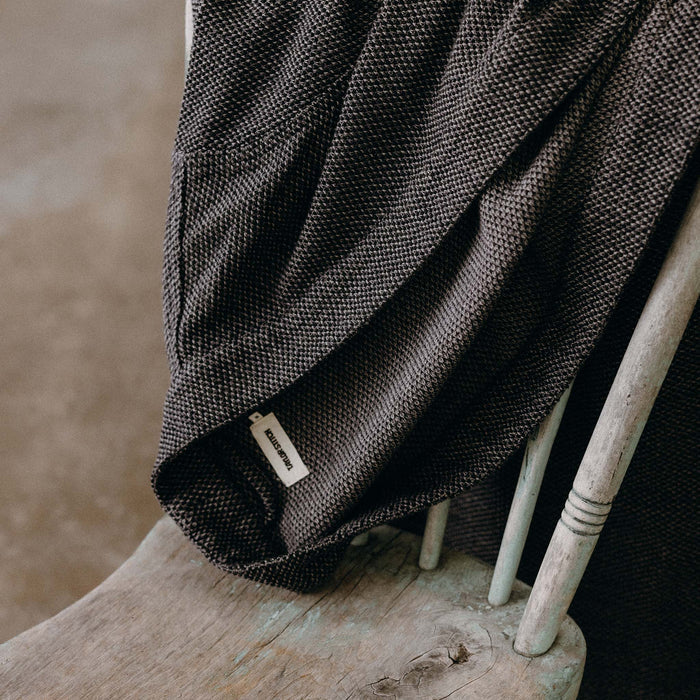 The Apres Robe in Charcoal Sashiko folded on a chair