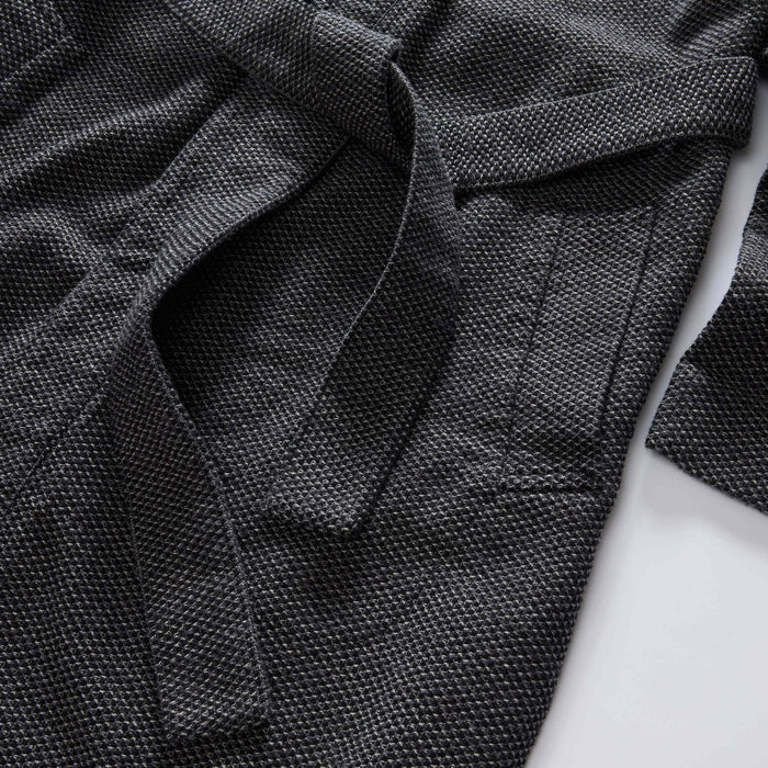 editorial flatlay of the pocket on The Apres Robe in Charcoal Sashiko