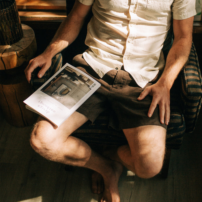 fit model sitting in The Apres Short in Espresso Hemp
