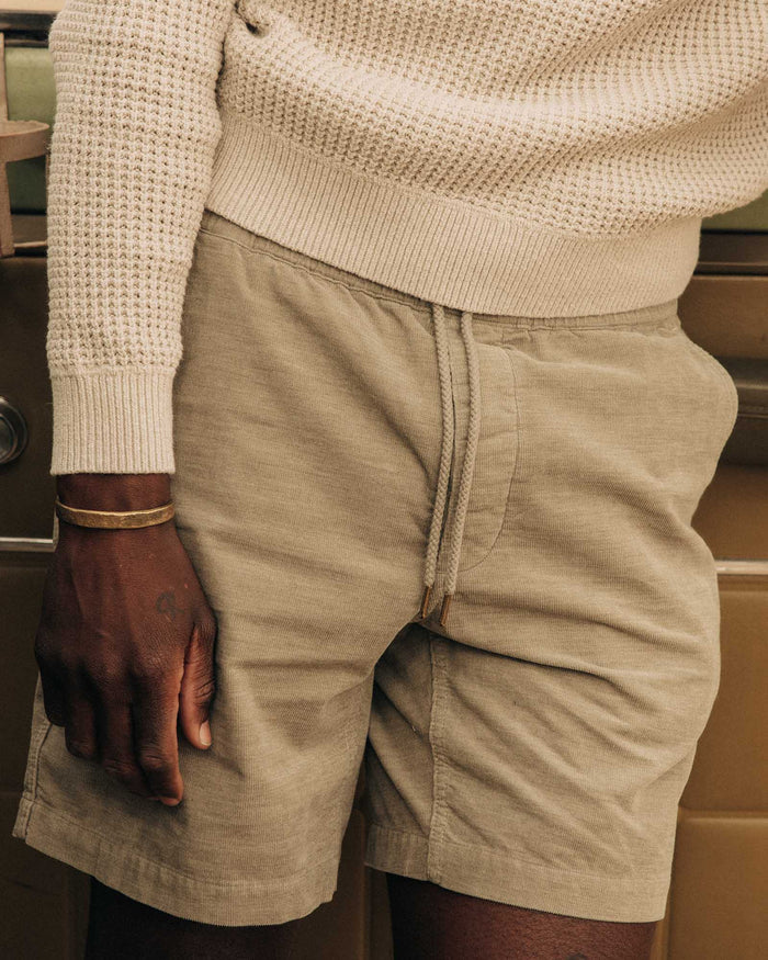 fit model leaning against the wall wearing The Apres Short in Heather Moss Pincord