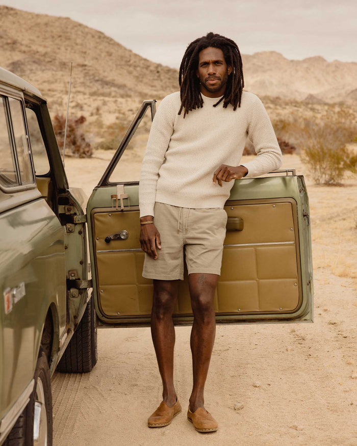fit model leaning against the car door wearing The Apres Short in Heather Moss Pincord