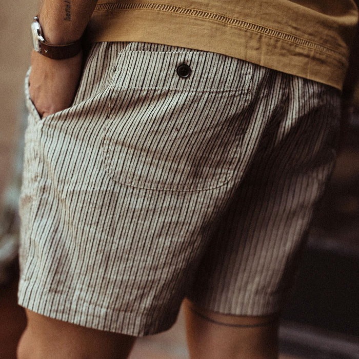 fit model showing the back button pocket on The Apres Short in Morita Stripe
