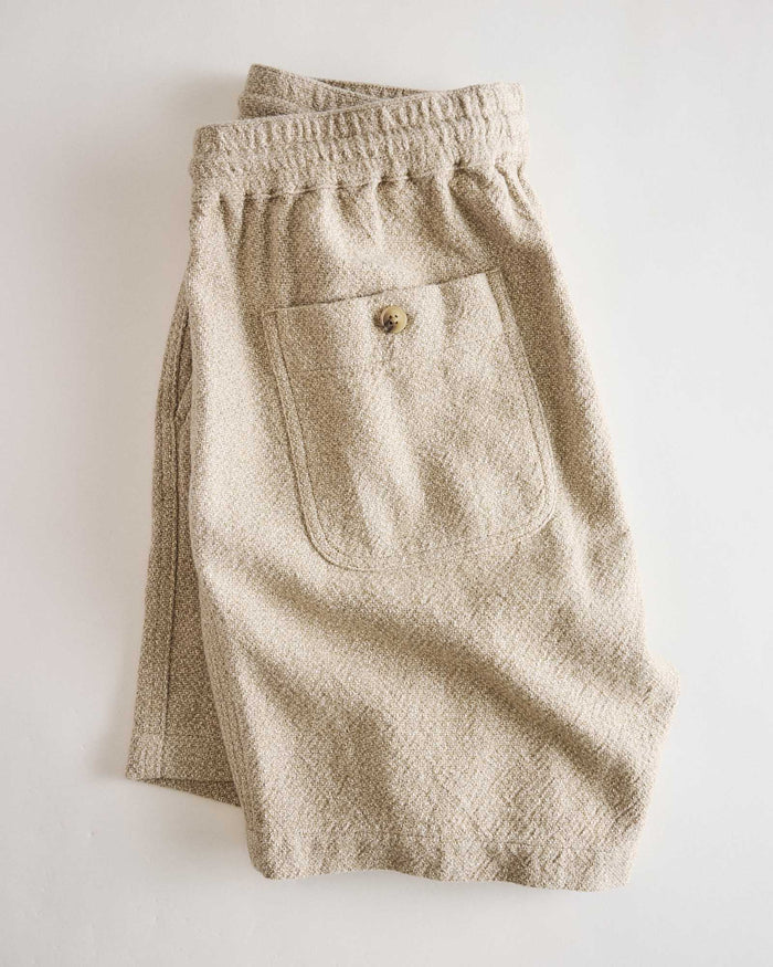 flatlay of the back of The Apres Short in Oat Linen Tweed