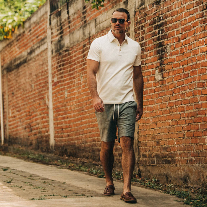 fit model wearing The Apres Short in Olive Pin Dot, walking down street