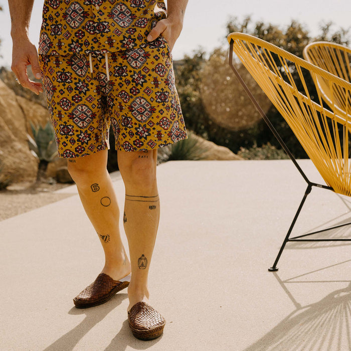 fit model with his hand in the pocket of The Apres Short in Tarnished Gold