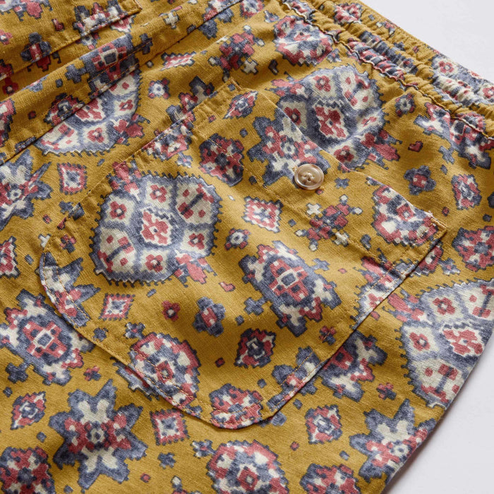 material shot of the back pocket on The Apres Short in Tarnished Gold