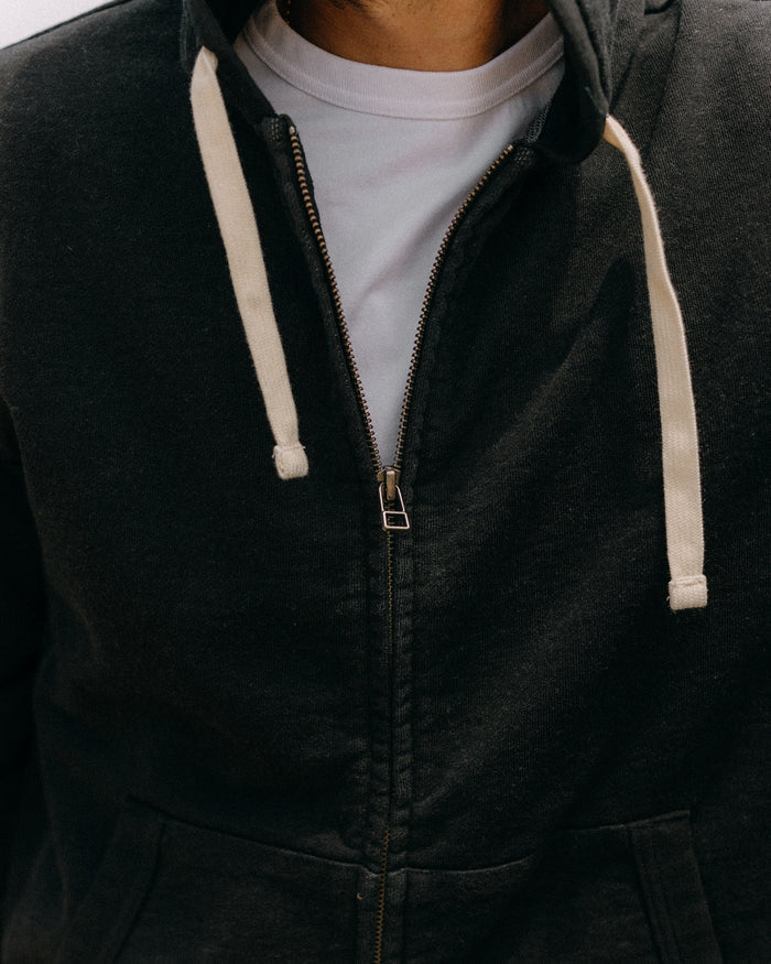 fit model showing off the zipper on The Apres Zip Hoodie in Black Indigo Terry