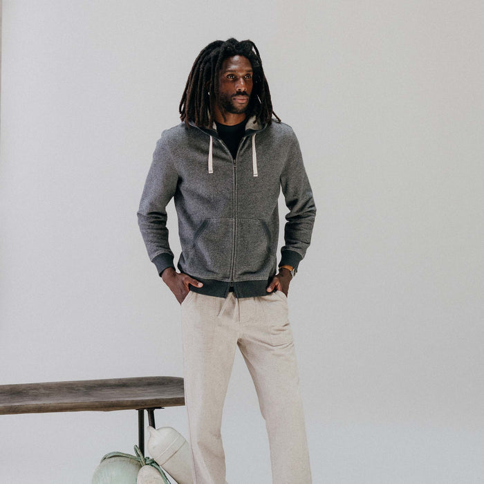 fit model with his hands in his pocket wearing The Apres Zip Hoodie in Graphite French Terry Twill