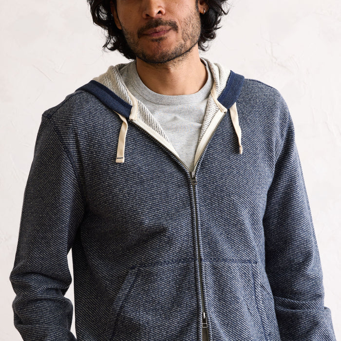 fit model showing the front of The Apres Zip Hoodie in Heather Navy Terry