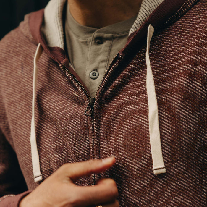 fit model zipping up The Apres Zip Hoodie in Merlot French Terry Twill
