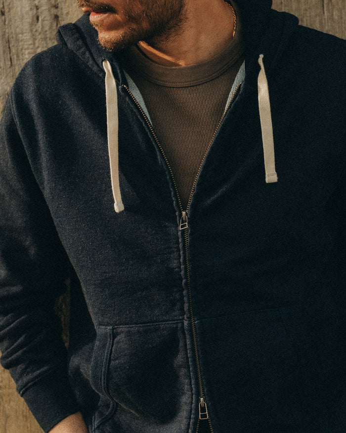 fit model posing in The Apres Zip Hoodie in Rinsed Indigo Terry