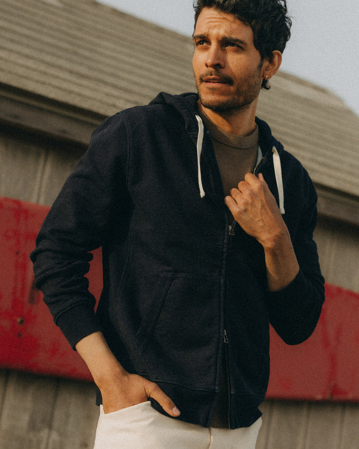 fit model posing in The Apres Zip Hoodie in Rinsed Indigo Terry