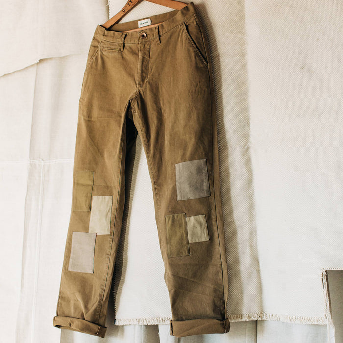 material shot of The Atelier and Repairs Chino in British Khaki, hanging in studio