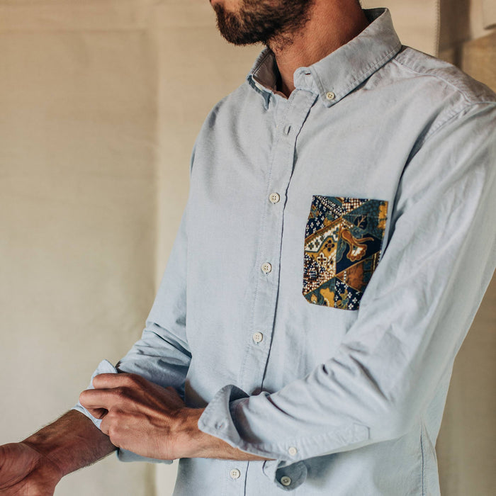 fit model wearing The Atelier and Repairs Jack in Washed Blue Oxford, cuffed sleeved