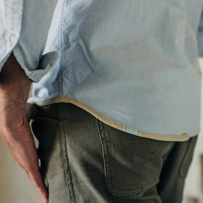 fit model wearing The Atelier and Repairs Jack in Washed Blue Oxford, bottom detail