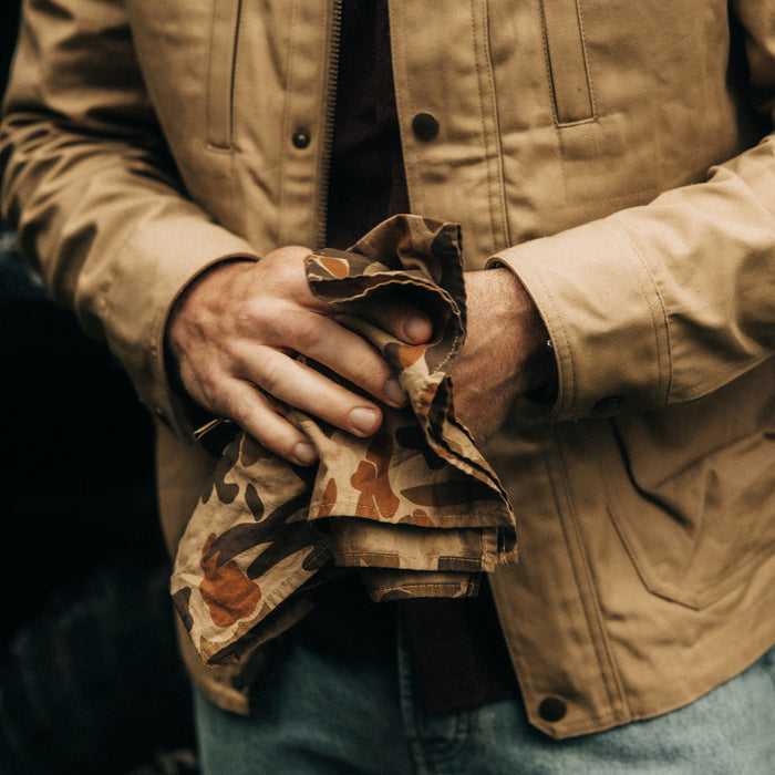 fit model wiping his hands with The Bandana in Arid Camo