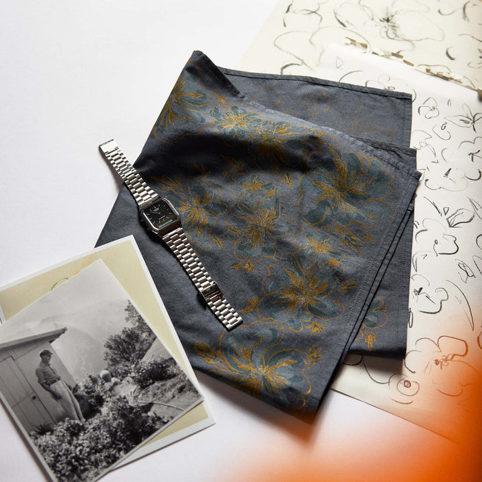 editorial image of The Bandana in Dark Blue Floral with a watch and images on top