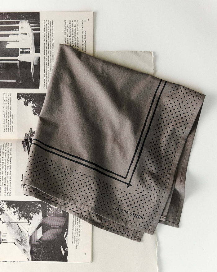 editorial flatlay of The Bandana in Smoked Olive Pindot folded
