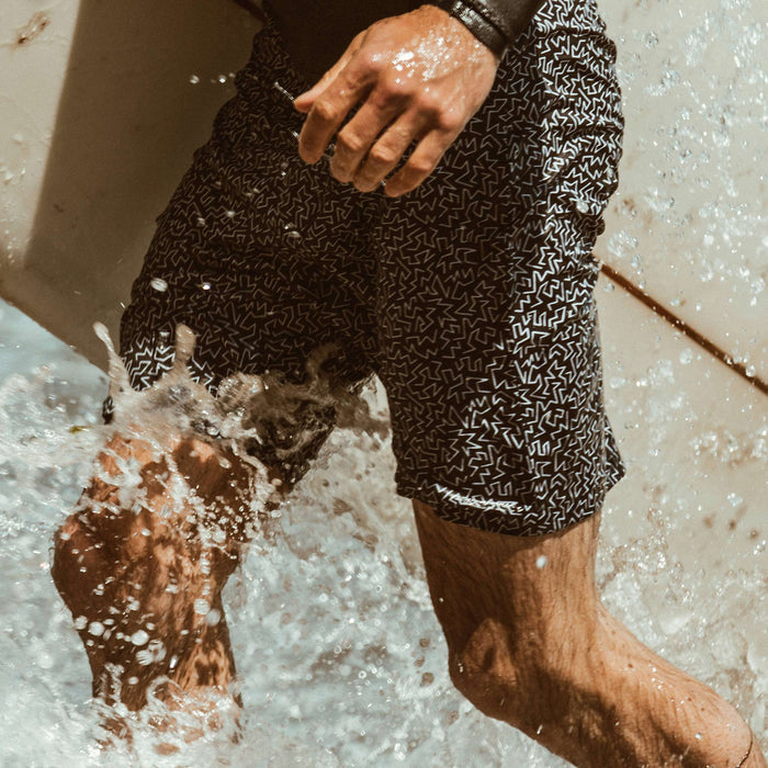A close up shot of fit model wearing the surf shorts