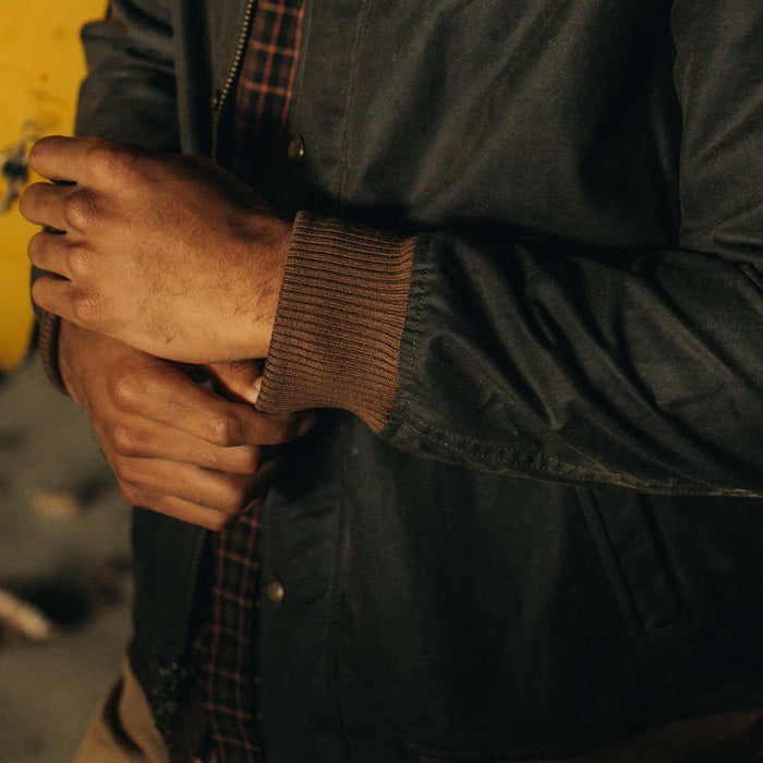 fit model adjusting the ribbed cuffs on The Bomber Jacket in Bark EverWax