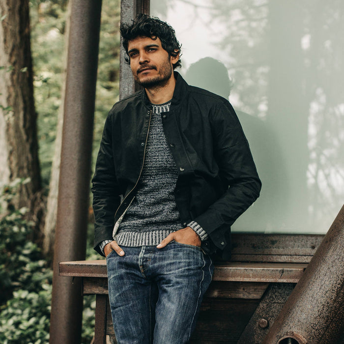 fit model wearing The Bomber Jacket in Black Dry Wax, hands in pockets
