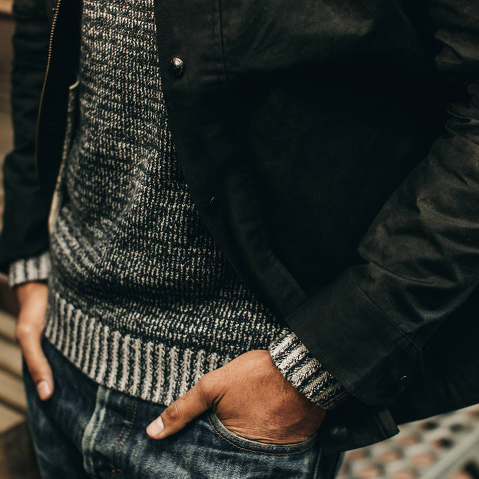 fit model wearing The Bomber Jacket in Black Dry Wax, hands in pockets, close up