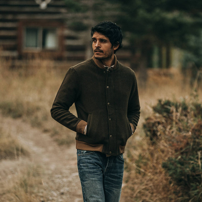 fit model wearing The Bomber Jacket in Olive Wool, hands in pockets