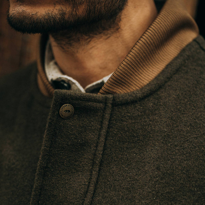 fit model wearing The Bomber Jacket in Olive Wool, button detail