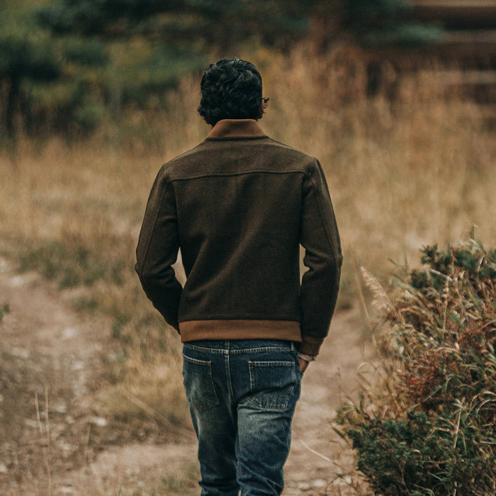 fit model wearing The Bomber Jacket in Olive Wool, back