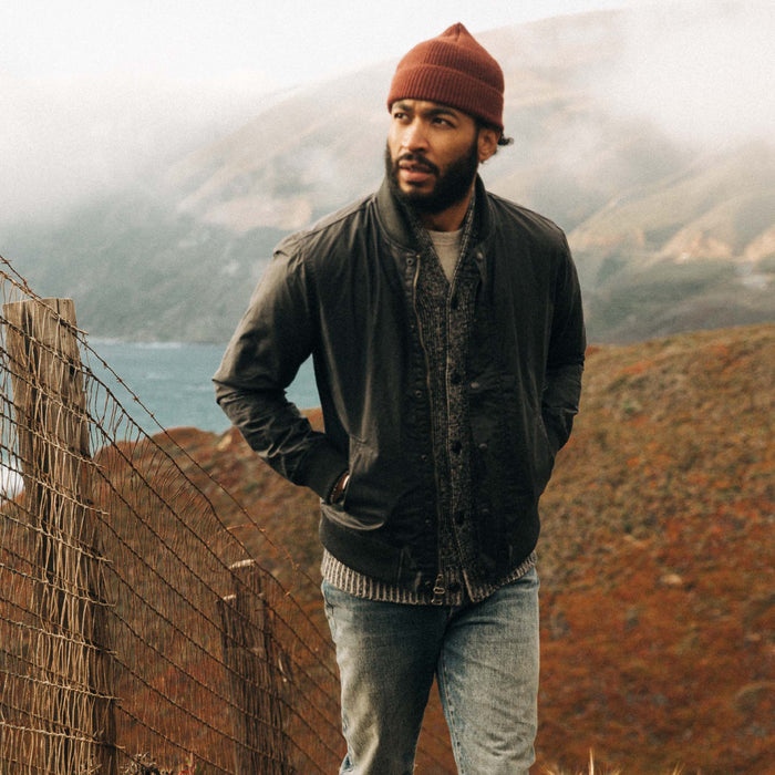 fit model wearing The Bomber Jacket in Waxed Navy on the coast of Big Sur