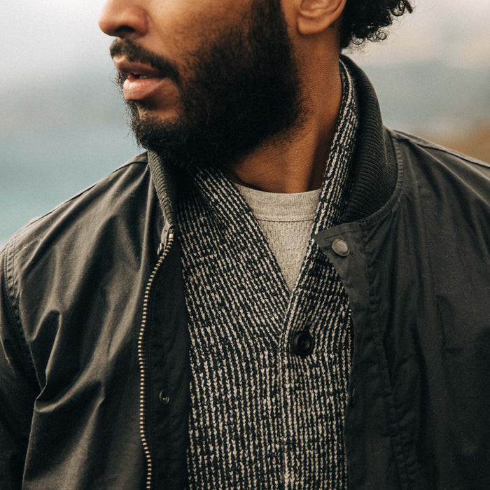 fit model wearing The Bomber Jacket in Waxed Navy over a sweater